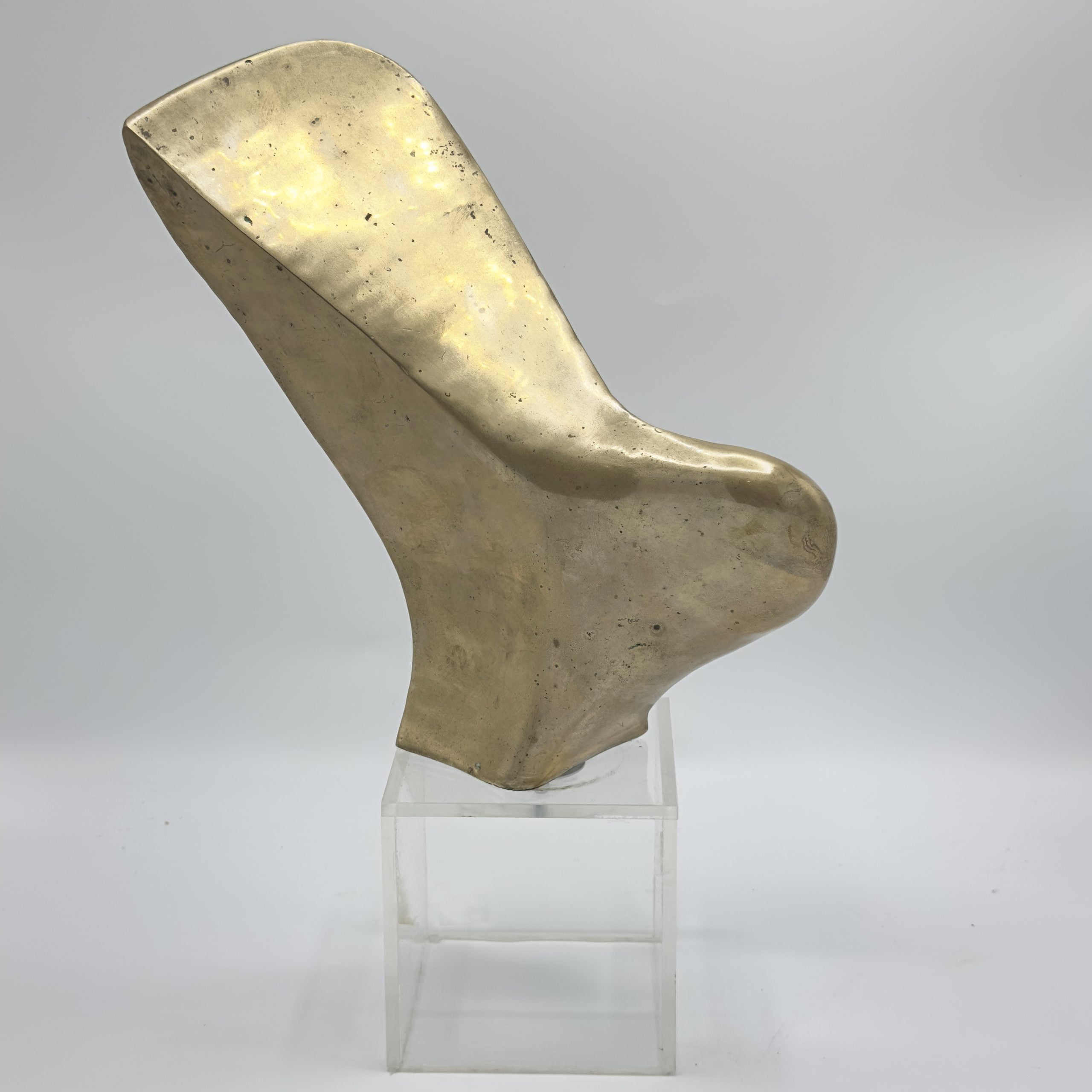 Vintage brass sculpture on clear acrylic base